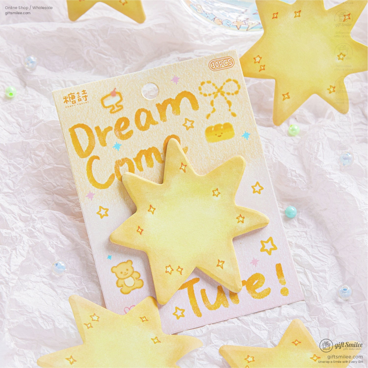 A vibrant yellow star sticky note with Dream Come True packaging, surrounded by colorful pastel beads