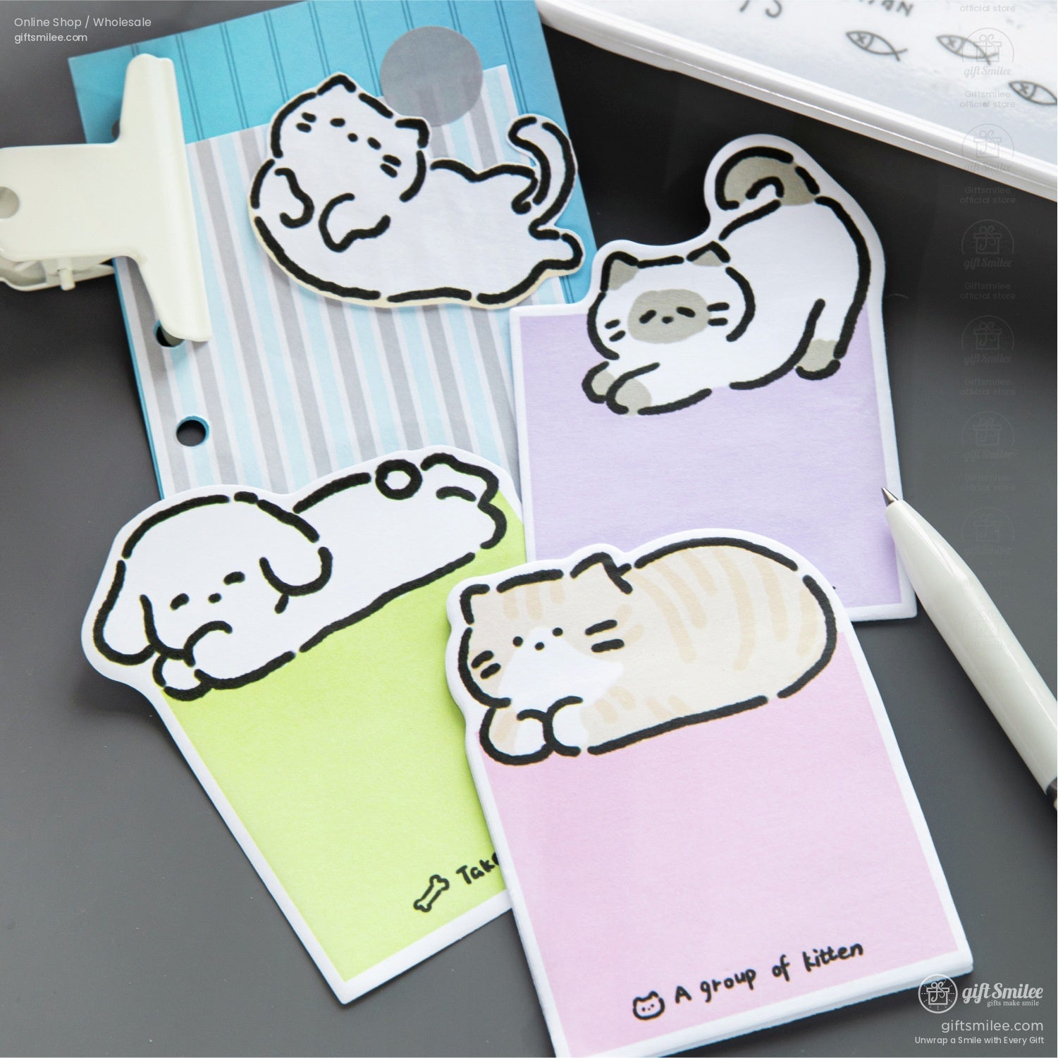 A mix of kitten and puppy sticky notes displayed on a notebook, ideal for office or school use
