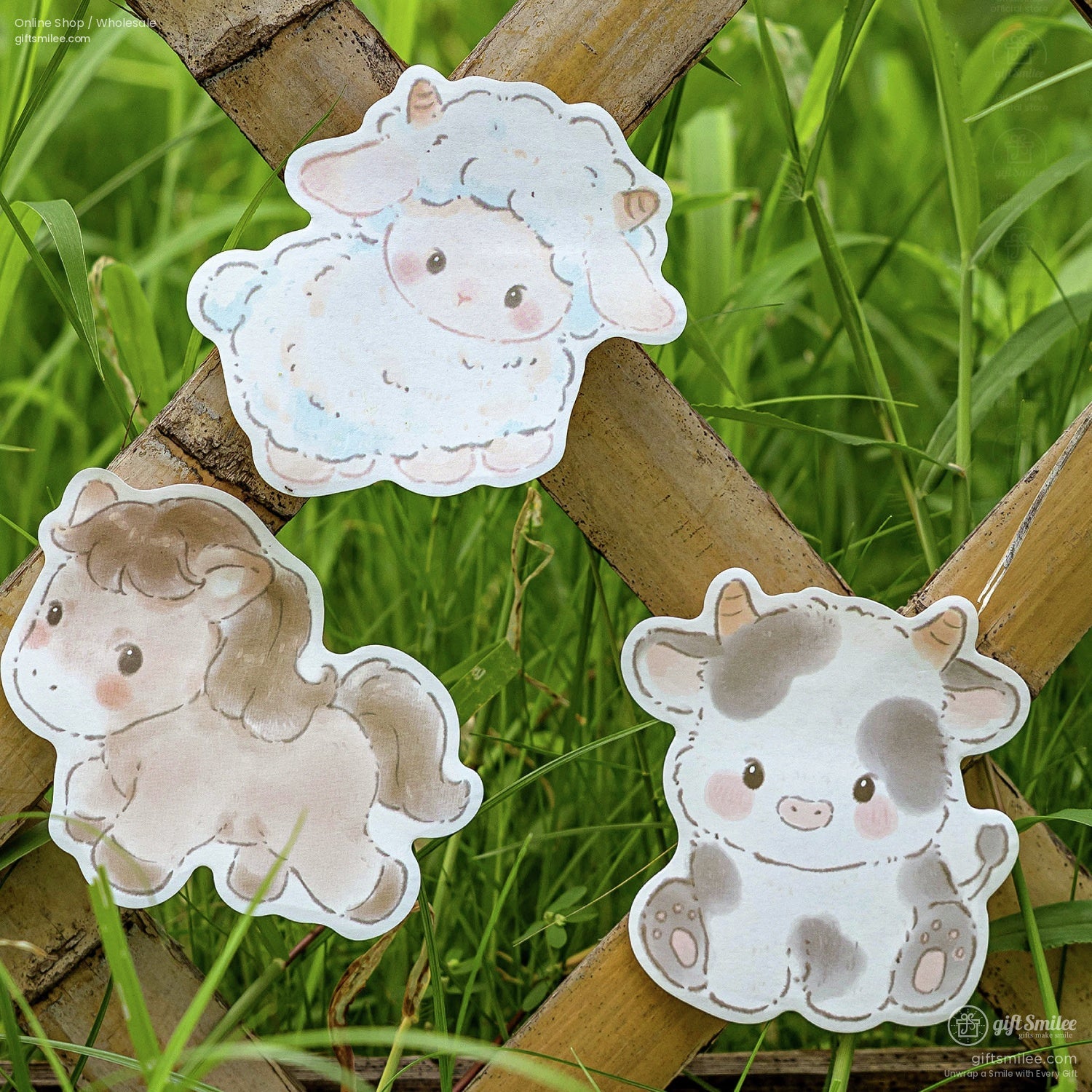 Cute cow, horse, and sheep stickers displayed outdoors against a grassy background