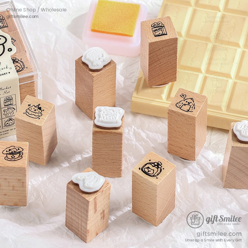Individual wooden stamps with cartoon prints arranged on a textured surface.