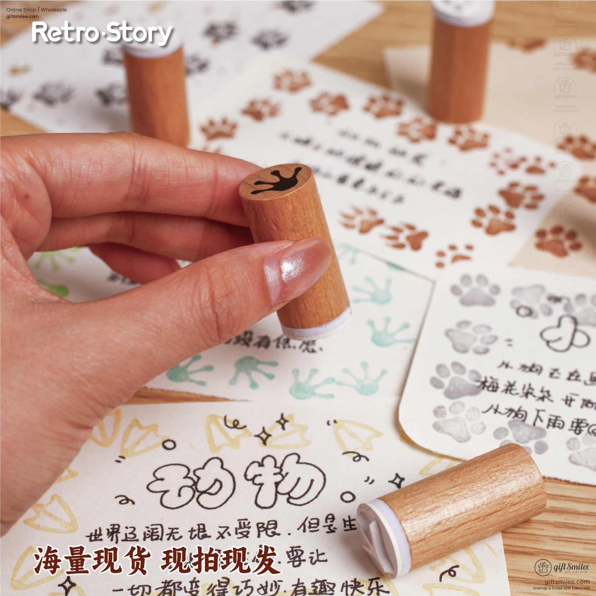 Close-up of a hand-held wooden stamp with black animal paw print design