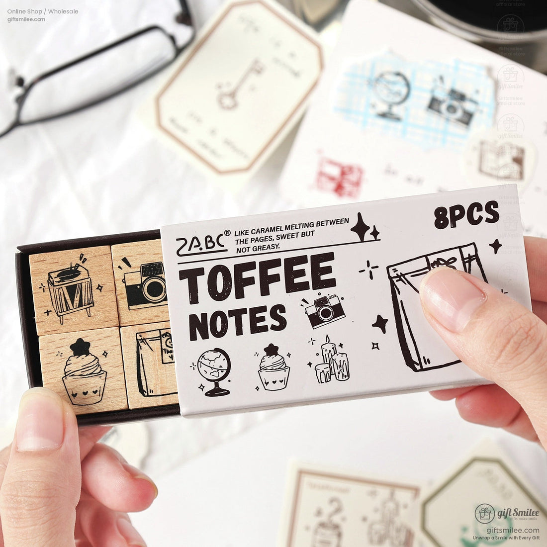 A collection of retro wooden stamps featuring daily life icons like books, globes, and cameras, displayed in elegant packaging