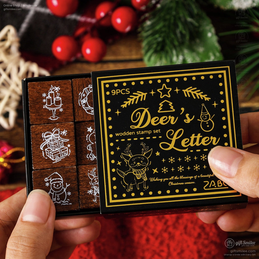 Wooden Christmas stamp set with 9 festive designs and black and gold packaging